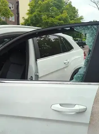 White car with broken side window Glass