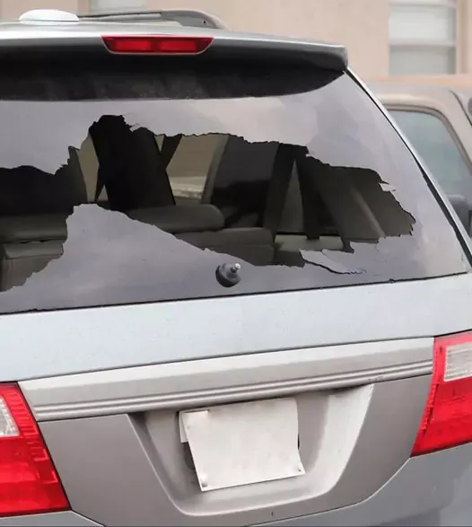 Rear of a car with a cracked, broken back glass needing rear window replacement