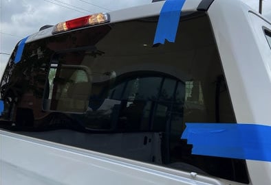 Taped rear window during mobile back glass replacement on a van in Memphis