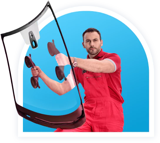 Technician wearing red uniform working on a car windshield with a suction cup tool