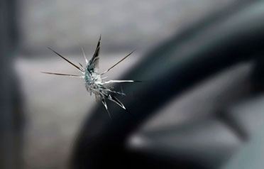 Star-shaped windshield crack from impact damage viewed from inside the vehicle