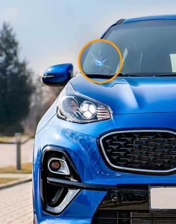 Blue car with highlighted windshield crack in need of repair on driver's side